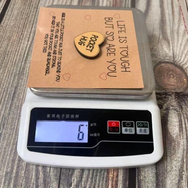 Pocket Hug: Engraved wooden token with a supportive message on a card, weighing 6 grams