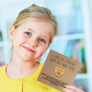 Pocket Hug wooden token: Engraved mini coin with "HUG" on a card with a girl. A personalized gift for retail & events.