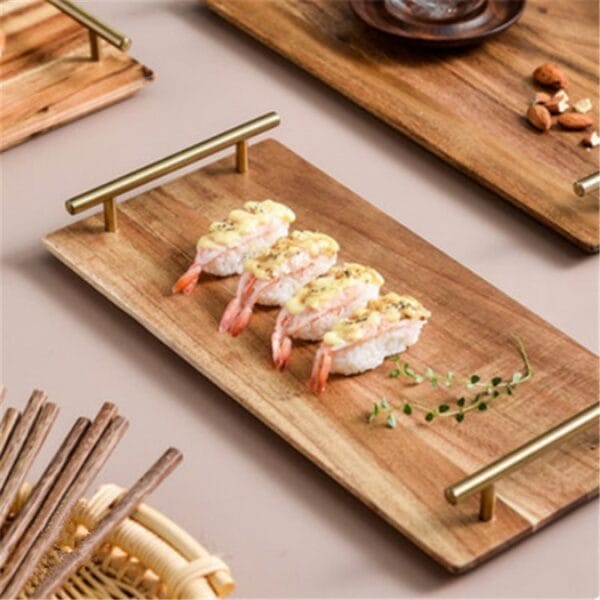 Acacia serving tray with copper handles holding sushi. Personalized wooden tray ideal for wedding gifts.