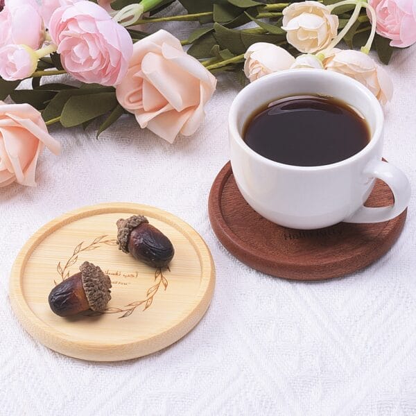 Wooden coasters with coffee cup & pink flowers. Round bamboo coaster with acorns and Arabic text.
