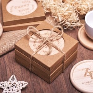Personalized wooden coasters in kraft boxes tied with twine. Unique wedding or anniversary favors.