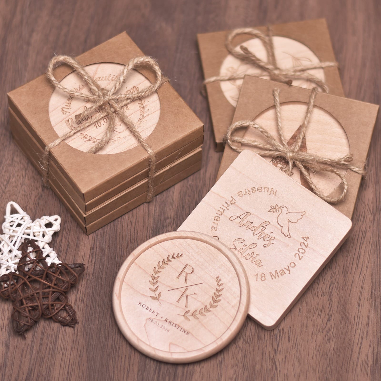 Personalized wooden coasters in gift boxes with twine bows. Engraved designs for weddings and baptisms.