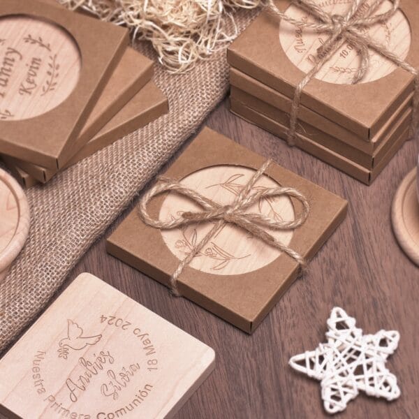Wooden coasters in boxes tied with twine, some engraved with text and designs.