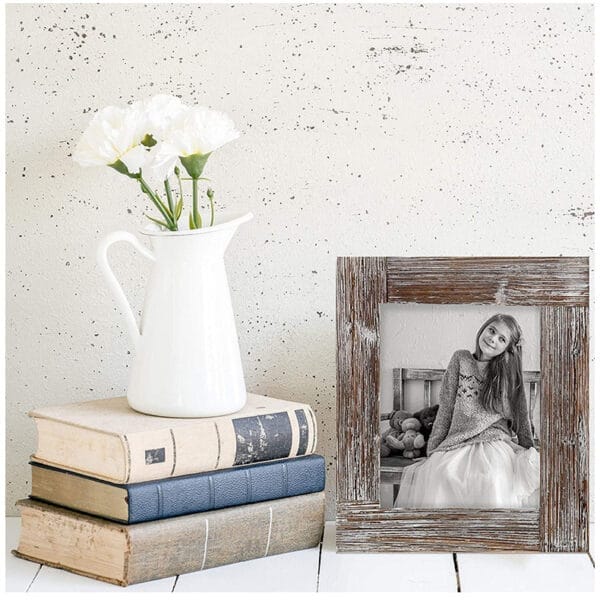 AUTO-DRAFT rustic wooden picture frame displayed with books and flowers.