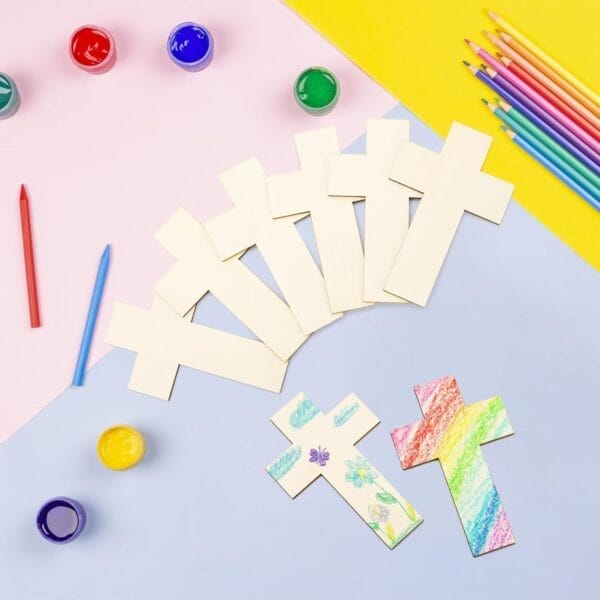 Wooden crosses for crafting with paint, crayons, and colorful backgrounds.