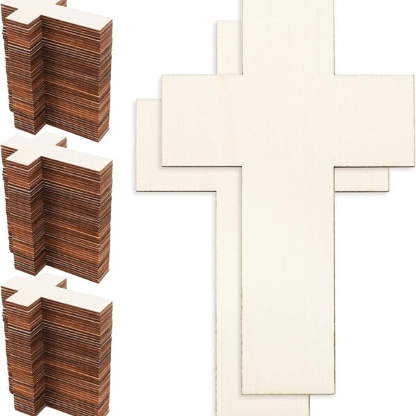 Stacks of unfinished wooden crosses, some stacked and some laid out flat.