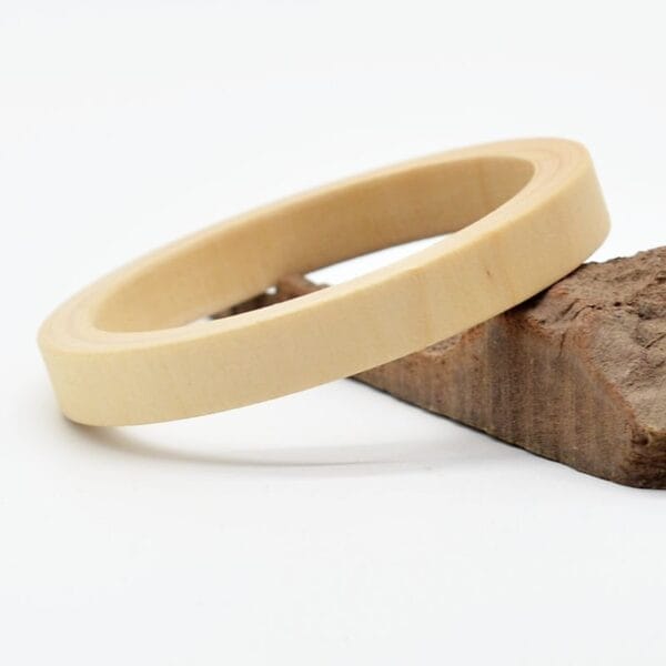 Unpainted Wooden Bangle: Raw wooden bracelet blank for DIY jewelry projects, showcasing natural wood grain.