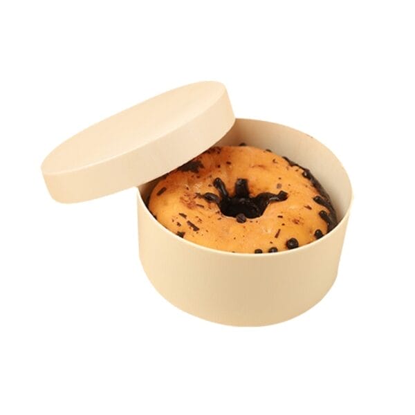 Donut in round beige box with lid, ready to eat or gift