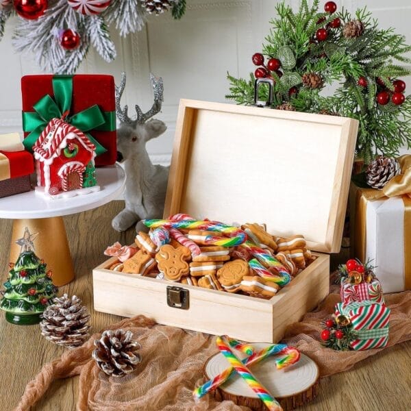 Wooden box filled with Christmas cookies and candy canes, surrounded by festive decorations.