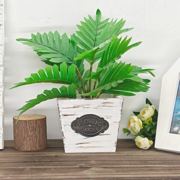 AUTO-DRAFT plant in a distressed white pot with "Flowers Garden" plaque.