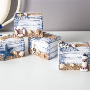 Nautical decor: Four small, blue and white wooden chests with starfish, shells, and life preserver accents. Wholesale Wooden Trinket Boxes