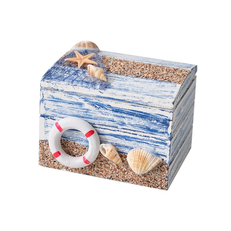 AUTO-DRAFT nautical-themed wooden box with seashells, starfish, life preserver, netting, and sand decoration.