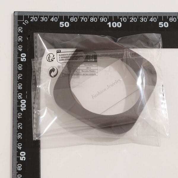 Brown geometric collar necklace in packaging. Fashion jewelry accessory.