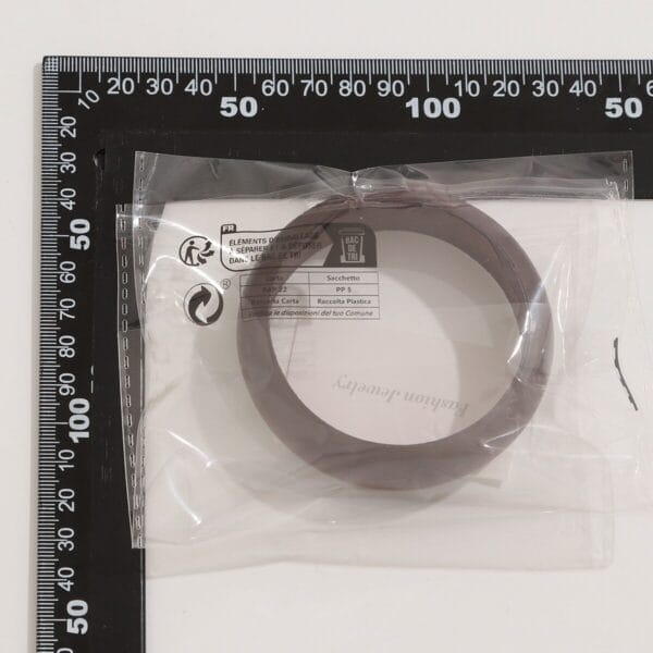 AUTO-DRAFT: Brown bangle bracelet in packaging on a measuring mat.