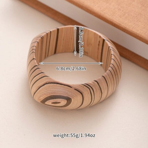 Vintage handcrafted light brown wooden bangle with dark grain patterns