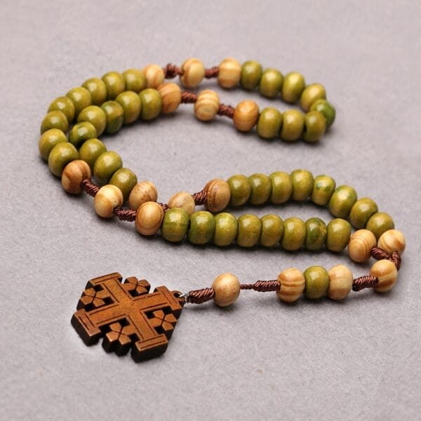Wooden Cross Pendant Bulk: Polished natural wood rosary necklace with green and light wood beads.