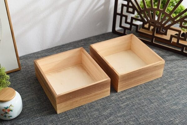 Wooden Drawer Box Manufacturers: Two square, light-colored wooden boxes with visible wood grain.