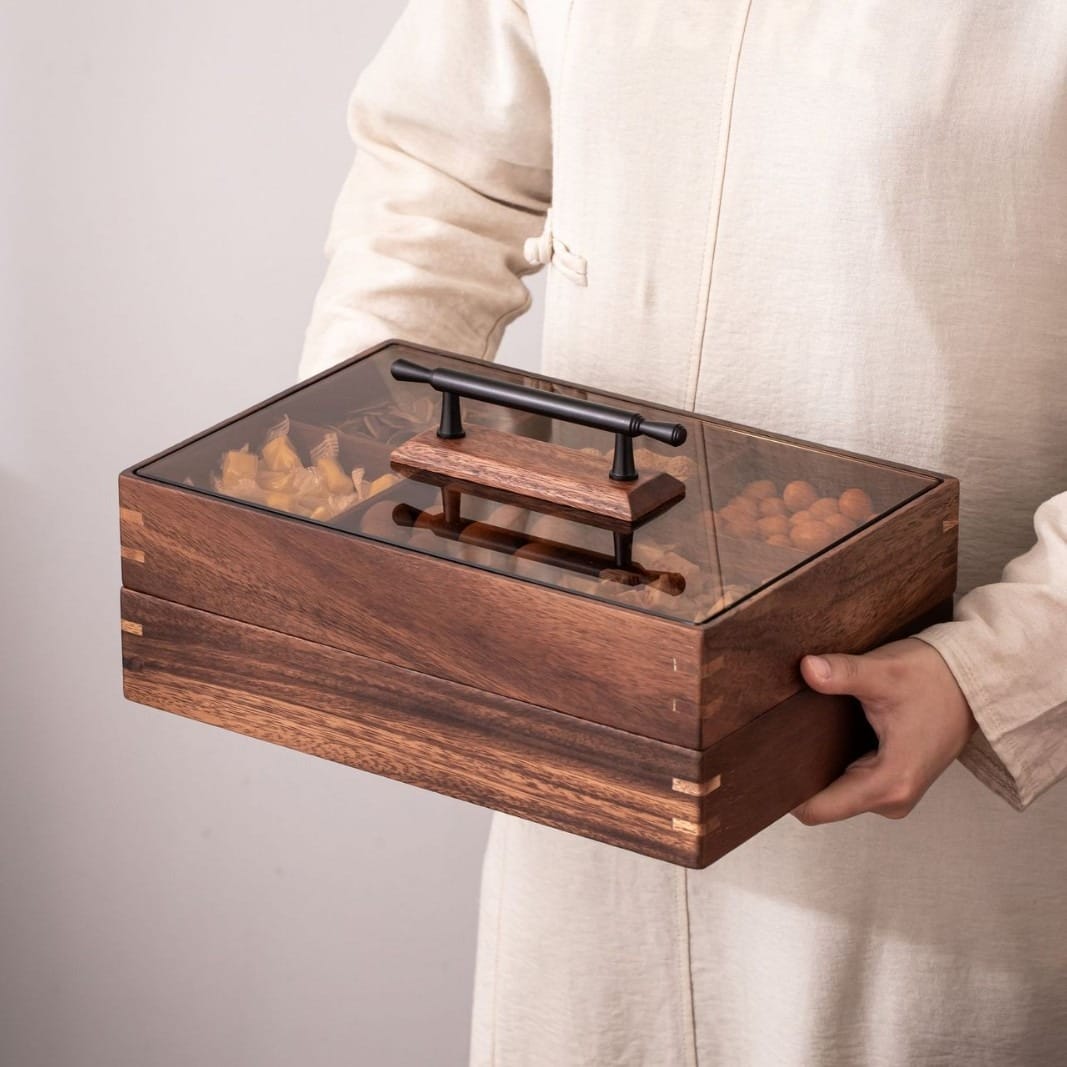 Premium Walnut Wooden Dry Fruit Box: Stackable 6-compartment snack & candy box with glass lid, held by a person.