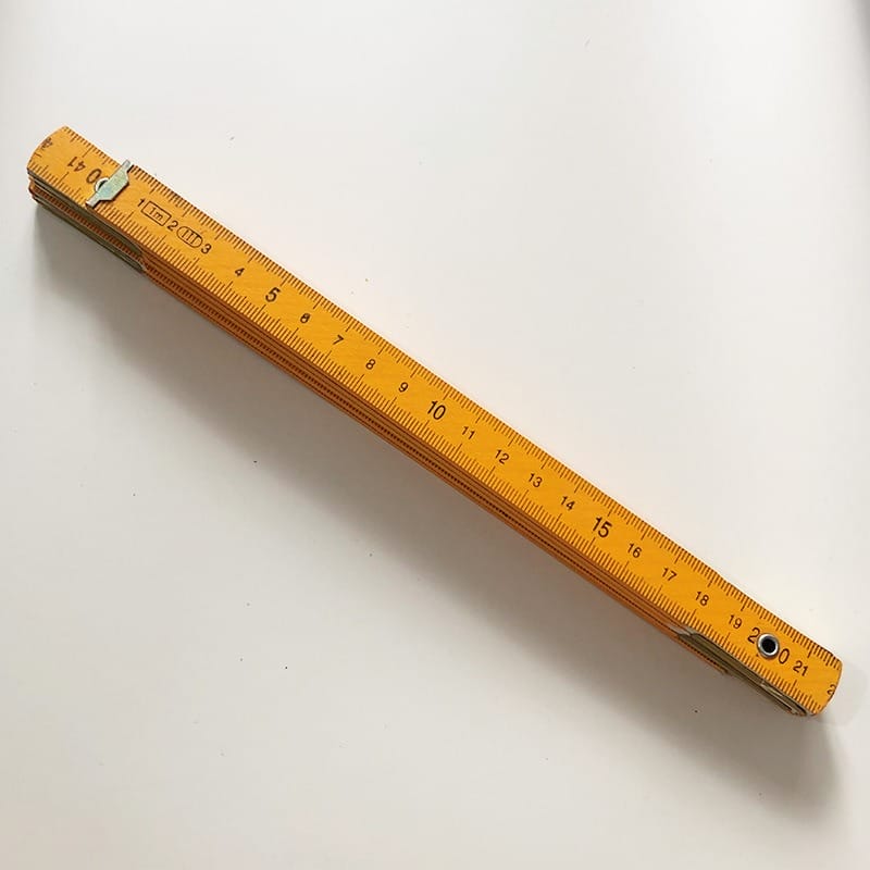 Orange wooden folding ruler, 1.5m 5-section metric ruler, partially extended.