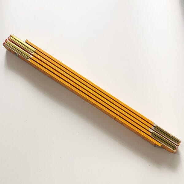 Orange 1.5m wooden folding ruler with 5 sections, metric measurements.