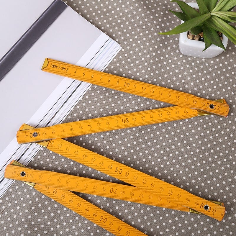 1.5m 5-Section Metric Ruler: Orange wooden folding ruler, extended to show measurements.