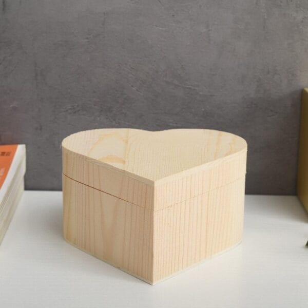 Wooden heart-shaped box with lid.