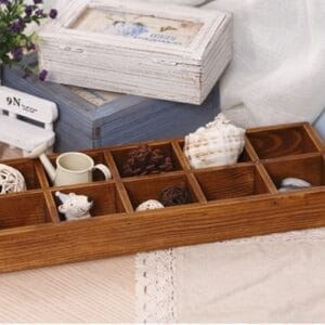 AUTO-DRAFT: Rustic wooden box with 10 compartments, filled with decorative items like a seashell and mini watering can.