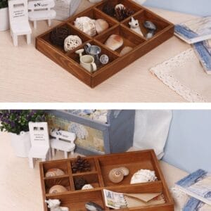 Brown wooden divided tray with seashells, pinecones, and miniature decor. Decorative organizer for small items.