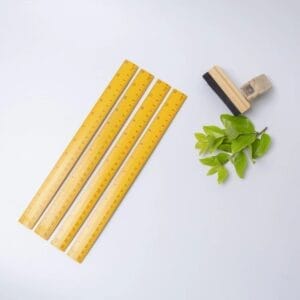Wholesale Wooden Yardsticks: Orange painted yellow wood rulers for schools, brush, and leaves.